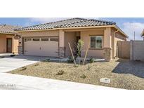 Charming home featuring a tile roof, low maintenance desert landscaping, and an attached two car garage at 24629 W St Catherine Ave, Buckeye, AZ 85326