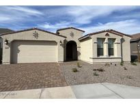 Inviting single-story home boasts a two-car garage, desert landscaping, and neutral color palette at 10262 W Columbus Ave, Avondale, AZ 85392