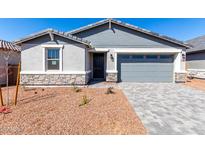 Charming single-story home featuring a grey color palette, desert landscaping, and a two-car garage at 5344 W Manzanita Dr, Glendale, AZ 85302