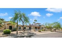 Stunning home exterior showcasing desert landscaping and architectural design details under a bright, partly cloudy sky at 10050 N 58Th Pl, Paradise Valley, AZ 85253
