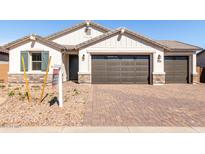 Beautiful single-Gathering home with a two-car garage, desert landscaping, and a paved brick driveway at 12322 W Marguerite Ave, Avondale, AZ 85323