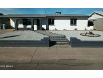 Charming ranch home with well-manicured landscaping and walkway at 8606 N 32Nd Ave, Phoenix, AZ 85051