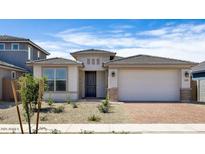 Inviting single-story home with a brick-paved driveway and low-maintenance desert landscaping at 25118 N 171St Ln, Surprise, AZ 85387