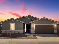 Charming single-story home with neutral paint, stone accents, and a two-car garage at dusk at 3649 E Alexander Dr, San Tan Valley, AZ 85143