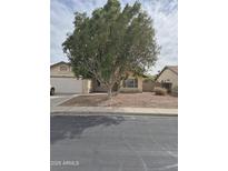 Charming single-story home featuring a well-maintained lawn and mature shade tree at 6623 N 85Th Ave, Glendale, AZ 85305