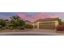 Beautiful desert home exterior with landscaped yard and two-car garage at 12368 W Running Deer Trl, Peoria, AZ 85383