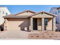 Charming single-story home with stone accents, a tile roof, and a two-car garage at 20254 W Roma Ave, Litchfield Park, AZ 85340