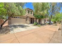 Charming home with a well-maintained front yard, mature trees, and a spacious three car garage at 35202 N 30Th Dr, Phoenix, AZ 85086