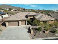 Single-story home with tile roof, large driveway, and desert landscaping at 42023 N Bridlewood Way, Phoenix, AZ 85086