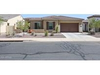 One-story home with tile roof, shutters, and attached garage at 14133 S 179Th Ave, Goodyear, AZ 85338