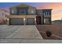 Two-story home with a three-car garage, a red door, and desert landscaping at 12943 W Mclellan Rd, Glendale, AZ 85307