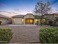 Desert landscape with gravel and a large patio at 18144 W Wind Song Ave, Goodyear, AZ 85338