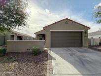 Single-story home with a two-car garage and desert landscaping at 3559 E Archer Dr, San Tan Valley, AZ 85140