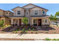 Inviting townhome featuring manicured landscaping, covered porches, and a welcoming atmosphere at 2888 N Evergreen St, Buckeye, AZ 85396