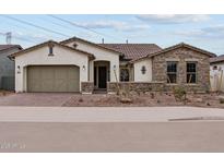 Beautiful single-story home with a brick-paved walkway and meticulously landscaped front yard at 12315 W Parkway Ln, Avondale, AZ 85323