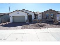 Charming single-story home featuring a neutral color palette, well-manicured landscaping, and an attached two-car garage at 12315 W Parkway Ln, Avondale, AZ 85323