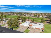 Beautiful aerial view of a golf course community with well-maintained landscaping and single Gathering homes at 10224 E Michigan Ave, Sun Lakes, AZ 85248