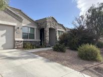 One-story home with stone accents and a landscaped front yard at 30346 W Columbus Ave, Buckeye, AZ 85396