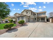 Charming two-story home showcasing desert landscaping, a spacious driveway, and a welcoming facade, inviting you to explore further at 1392 E Baker Dr, San Tan Valley, AZ 85140