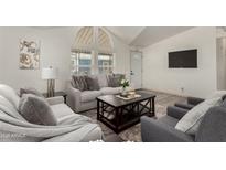 Inviting living room with plush seating, stylish decor, and bright natural light from the large windows at 2233 E Behrend Dr # 210, Phoenix, AZ 85024