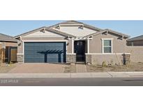 One-story home with a dark-blue garage door and landscaped front yard at 17798 W Coolidge St, Goodyear, AZ 85395