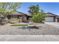 Brick ranch house with a landscaped front yard, and a two-car garage at 19219 N 33Rd Ave, Phoenix, AZ 85027