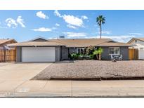 Charming single-story home featuring a spacious driveway and desert landscaping for low maintenance appeal at 3425 W Acoma Dr, Phoenix, AZ 85053