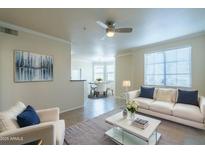 Bright living room features neutral walls, white furniture, and modern decor at 1941 S Pierpont Dr # 1038, Mesa, AZ 85206