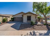 Charming single-story home featuring desert landscaping, a two-car garage, and a walkway framed with stone columns at 4067 S White Dr, Chandler, AZ 85249