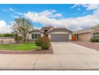Charming single-story home featuring a desert landscaped front yard and two-car garage at 10209 W Jessie Ln, Peoria, AZ 85383