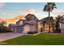 Beautiful two-story home featuring a well-maintained lawn, mature palm trees, and a grand entryway at 760 N Ithica St, Gilbert, AZ 85233