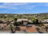 Aerial view of two-story house with desert landscaping and distant mountain views at 3208 N Mansfield Dr, Litchfield Park, AZ 85340
