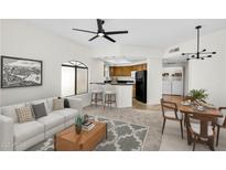 Inviting living room featuring contemporary furnishings, an open layout, and seamless flow to the kitchen and dining area at 10030 W Indian School Rd # 218, Phoenix, AZ 85037