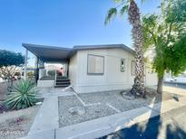 Charming single-story home with a covered porch and well-maintained landscaping at 9427 E University Dr # 100, Mesa, AZ 85207
