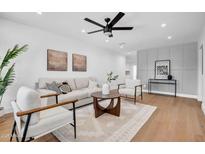 Bright living room with a ceiling fan, modern decor, light hardwood floors and lots of natural light at 2126 E Watson Dr, Tempe, AZ 85283