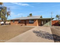 Charming single-story brick home with a well-maintained front yard and long driveway at 2246 W Mulberry Dr, Phoenix, AZ 85015