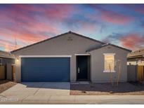 Charming single-story home featuring a blue garage door, desert landscaping, and a welcoming entryway at 3409 E Alexander Dr, San Tan Valley, AZ 85143