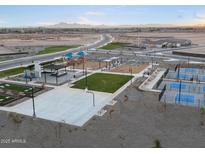 Aerial view of community amenities including playground, sports courts, and open green spaces at 36888 W Prado St, Maricopa, AZ 85138