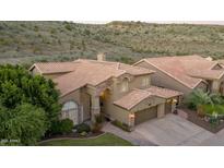 Stunning aerial view of a two-story home with a tile roof and landscaped yard at 1622 E Nighthawk Way, Phoenix, AZ 85048