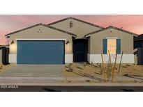 One-story house with blue garage door, landscaping, and light-colored exterior at 22550 W Tonopah Dr, Surprise, AZ 85387