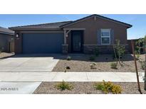 Charming single-story home with a two car garage, desert landscaping, and inviting curb appeal at 20293 N 225Th Dr, Surprise, AZ 85387
