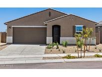 Inviting single-story home featuring a two-car garage, desert landscaping, and a classic brown stucco facade at 20357 N 225Th Dr, Surprise, AZ 85387