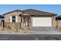 Single-story home with a two-car garage and desert landscaping at 22526 W Tonopah Dr, Surprise, AZ 85387
