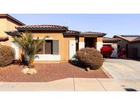 One-story house with terracotta tile roof, desert landscaping, and a two-car driveway at 25600 W St James Ave, Buckeye, AZ 85326