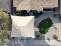 Bird's eye view of a home with a putting green, covered parking, and desert landscaping at 4121 W Medlock Dr, Phoenix, AZ 85019