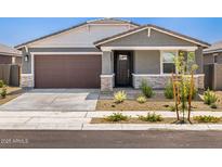 Charming single-story home featuring a two-car garage and well-maintained xeriscaped front yard at 20331 N 225Th Dr, Surprise, AZ 85387