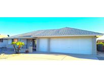 Ranch style home with two-car garage and landscaped front yard at 8203 E Nopal Ave, Mesa, AZ 85209