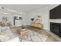 Cozy living room featuring a fireplace, open floor plan, and modern decor at 3845 E Greenway Rd # 131, Phoenix, AZ 85032