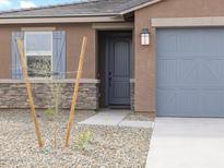 Charming single Gathering home with a low maintenance yard and gray accents at 16025 W Cottontail Ln, Surprise, AZ 85387
