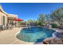Inviting pool featuring a rock waterfall, cool deck, and a refreshing ambiance for outdoor relaxation at 3248 N Boulder Cyn, Mesa, AZ 85207